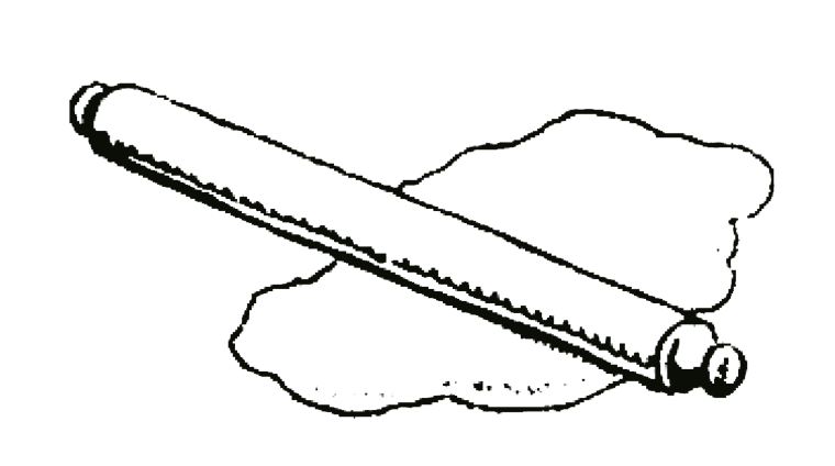 A rolling pin on pastry